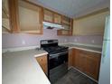Dated kitchen with wood cabinets and stainless steel stove/oven at 3789 Waldrop Ln, Decatur, GA 30034