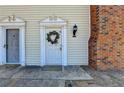 Up close front door, showcasing brick chimney, and wreath on door at 5554 Clover Rise Ln, Norcross, GA 30093