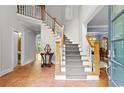 Inviting foyer features a staircase with white railings, tiled floor, and an open view of the dining room at 1169 Dawn View Nw Ln, Atlanta, GA 30327