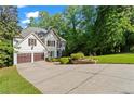 Beautiful two-story home with a two-car garage, landscaped yard, and lush greenery at 1169 Dawn View Nw Ln, Atlanta, GA 30327