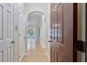 Hallway with hardwood floors, a brown entry door and arched doorways leading to other rooms at 4333 Dunwoody Park # 2107, Atlanta, GA 30338