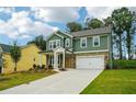 Charming two-story home features a stone and siding exterior, attached two-car garage, and well-manicured lawn at 5377 Heron Bay Blvd, Locust Grove, GA 30248