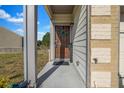 Inviting front porch with a charming wreath on the front door and potted plants, creating a warm entrance at 7884 Rock Rose Ln, Fairburn, GA 30213