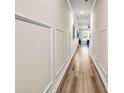 Bright hallway with hardwood floors and decorative wall panels that lead into the living area at 7884 Rock Rose Ln, Fairburn, GA 30213