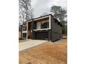 Beautiful two-story home with a black garage and modern design at 1921 Herbert Dr, Tucker, GA 30084