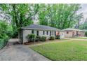 A cozy single-story home, complemented by a well-manicured lawn and mature trees at 2529 Habersham Dr, Decatur, GA 30032