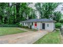 A charming single-story home with a lush green lawn and a welcoming red door at 2529 Habersham Dr, Decatur, GA 30032