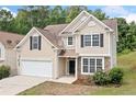 Charming two-story home with neutral siding, black shutters, and a two-car garage at 4405 Feather Way, Douglasville, GA 30135