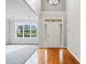 Bright foyer featuring hardwood floors, high ceilings, and an elegant chandelier at 4405 Feather Way, Douglasville, GA 30135