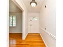 Bright entryway with hardwood floors, white walls, and views into the formal living room at 6651 Castleton Dr, Atlanta, GA 30328