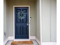 Stylish front door with a wreath, offering a warm welcome to this charming home at 1116 Silverbrooke Dr, Powder Springs, GA 30127