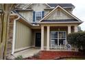 Inviting front porch with rocking chairs, stone accents, and a view of the landscaped yard at 1116 Silverbrooke Dr, Powder Springs, GA 30127