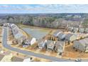 Aerial view of a community with a pond, showcasing the neighborhood layout and surrounding greenery at 137 Centennial Ridge Dr, Acworth, GA 30102
