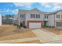 Lovely home featuring attached garage, brick accents, neutral siding, and well-maintained landscaping at 137 Centennial Ridge Dr, Acworth, GA 30102