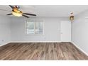 Bright living room featuring hardwood floors, a ceiling fan, and a window at 1432 Forest Villa Dr, Conyers, GA 30012