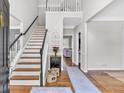 Bright foyer featuring hardwood floors, staircase, and an open view to the living spaces at 3921 Upland Way, Marietta, GA 30066