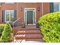 Inviting front entrance with brick steps, decorative plants, and stylish lighting fixtures at 3921 Upland Way, Marietta, GA 30066