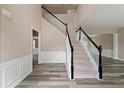 Spacious foyer featuring wood flooring, staircase with white railing and high ceiling at 550 Bayswater Way, Suwanee, GA 30024