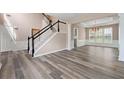 Spacious living room with wood flooring, large staircase and decorative chandelier at 550 Bayswater Way, Suwanee, GA 30024