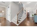 Inviting hallway featuring hardwood floors, a staircase, and stylish decor at 3883 Wakefield Hall Se Sq, Smyrna, GA 30080