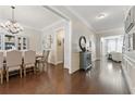 Elegant hallway and formal dining room featuring hardwood floors and decorative molding, creating a sophisticated ambiance at 3883 Wakefield Hall Se Sq, Smyrna, GA 30080
