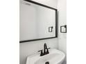 Stylish bathroom with a modern sink, black faucet and a large mirror at 10423 Commons Xing, Jonesboro, GA 30238