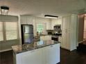 Modern kitchen featuring white cabinets, granite countertops, and stainless steel appliances at 1513 Wildwood Dr, Acworth, GA 30102