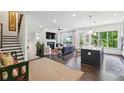 Open concept living space featuring dark hardwood floors, a fireplace, and stairs leading to the upper level at 476 Springer Nw Bnd, Marietta, GA 30060