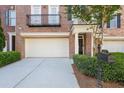 Exterior view showcasing two-car garage and well-maintained landscaping with green shrubbery at 478 Vinings Estates Se Dr # B02, Smyrna, GA 30126