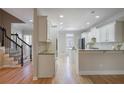 Bright kitchen with granite countertops, white cabinets, stainless steel appliances, and hardwood floors at 478 Vinings Estates Se Dr # B02, Smyrna, GA 30126