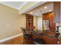 Modern kitchen with breakfast bar, dark granite countertops, and stainless steel appliances at 2277 Peachtree Ne Rd # 701, Atlanta, GA 30309