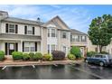 Inviting townhouse showcasing a bay window, front landscaping, and dedicated parking spot in a residential area at 1310 Kilmington Ct, Alpharetta, GA 30009