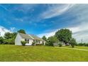 Well-maintained home featuring a large, green lawn and mature trees under a bright, sunny sky at 472 Linda Ln, Powder Springs, GA 30127