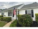 Inviting front porch with an American flag and manicured bushes enhancing the curb appeal at 472 Linda Ln, Powder Springs, GA 30127