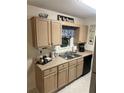 Cozy kitchen with light wood cabinets, neutral countertops, and modern appliances at 472 Linda Ln, Powder Springs, GA 30127
