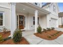 Inviting entrance with a wooden door and a well-manicured lawn leading to the front of the house at 3345 Hillshire Dr, Cumming, GA 30028