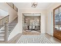 Elegant foyer with hardwood floors, a staircase, and an open view into the dining room at 3345 Hillshire Dr, Cumming, GA 30028