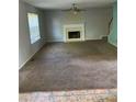 Spacious carpeted living room with a fireplace and large window for natural light at 5704 Winchester Pl, Lithonia, GA 30038