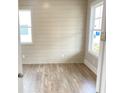 Bright bedroom with modern horizontal shiplap accent wall and ample natural light through two windows at 3355 Hillshire Dr, Cumming, GA 30028