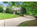 Charming home featuring a curved driveway and meticulously maintained landscaping at 706 Briarleigh Sw Ct, Mableton, GA 30126