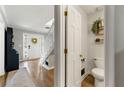 Stylish half-bathroom adjacent to the foyer with wood floors and decor at 706 Briarleigh Sw Ct, Mableton, GA 30126