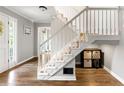 Bright foyer featuring a staircase with white railings and wood flooring at 706 Briarleigh Sw Ct, Mableton, GA 30126