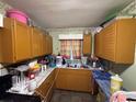 The kitchen has wood cabinets, matching appliances, and a light and airy window at 944 Stallings Se Ave, Atlanta, GA 30316