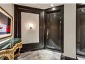 Elegant entry with patterned marble floors and striking dark wood door design at 2660 Peachtree Nw Rd # 4G, Atlanta, GA 30305