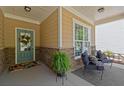 Welcoming porch area showcases comfortable seating and stylish stone accents at 357 Ridgewood Trl, Canton, GA 30115
