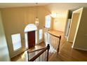 Open foyer featuring hardwood floors, high ceilings, and a view of the upper level at 4003 Preston Place Ln, Powder Springs, GA 30127