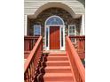 Inviting front porch with stone accents, painted steps, and a classic red front door at 4003 Preston Place Ln, Powder Springs, GA 30127