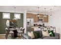 Open living room and dining area with modern decor and ample natural light at 99 Alameda St # 14, Loganville, GA 30052