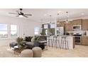Open-concept living room and kitchen with stainless steel appliances and hardwood flooring at 99 Alameda St # 14, Loganville, GA 30052
