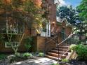 Inviting front entrance with brick stairs, black railing, and a well-maintained landscape at 5900 Fords Nw Rd, Acworth, GA 30101